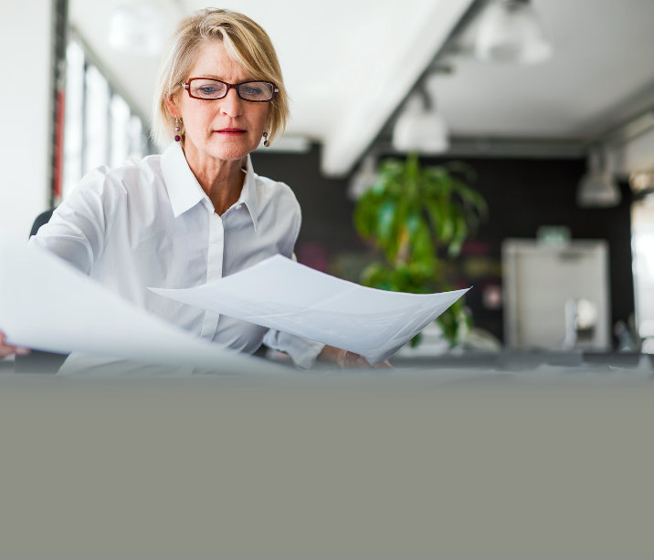 Business woman with glasses working at desk