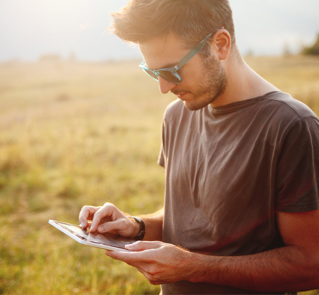 Young male checking online banking on tablet device