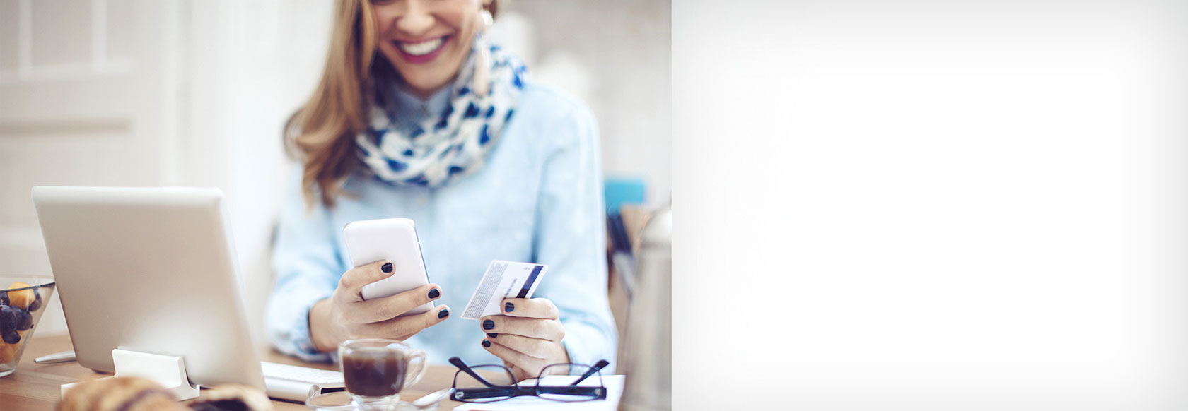 Woman using a debit card for a mobile transation. Smiling and happy.