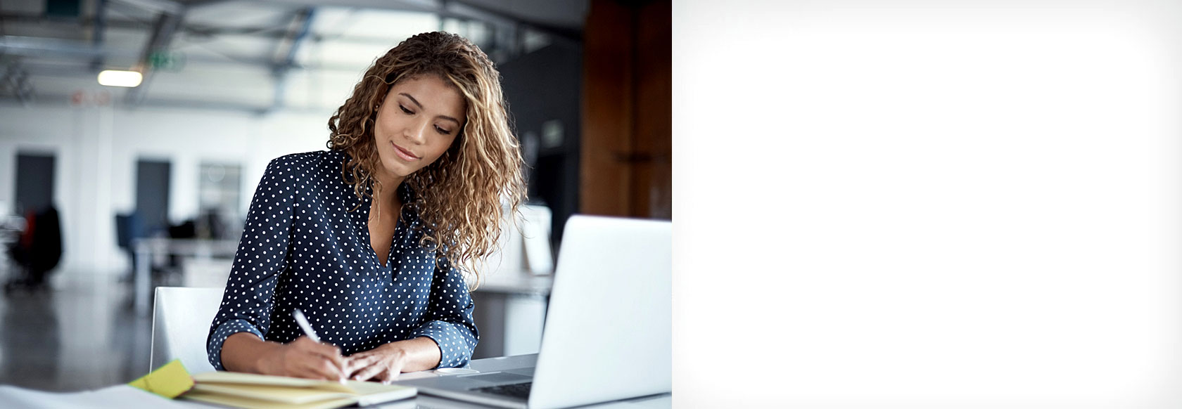 African American female on laptop in office setting