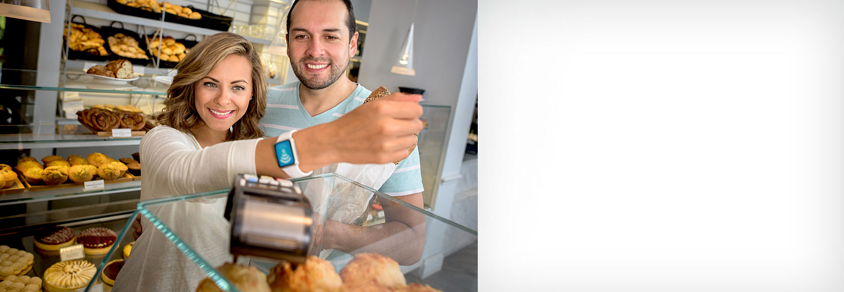 Happy couple using Apple Watch to pay