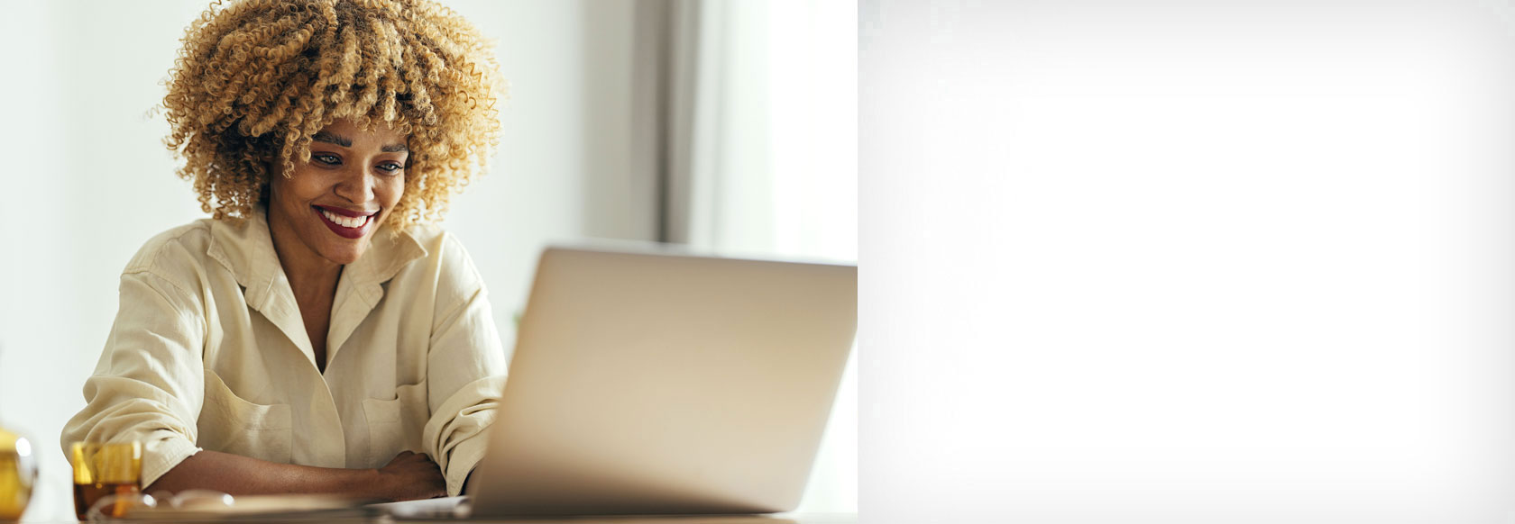 African American woman viewing laptop